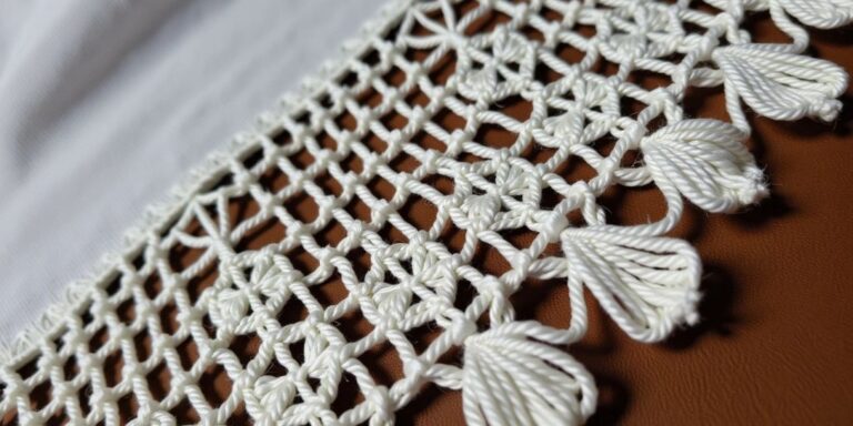Intricate Irish lace crochet with floral and leaf motifs.